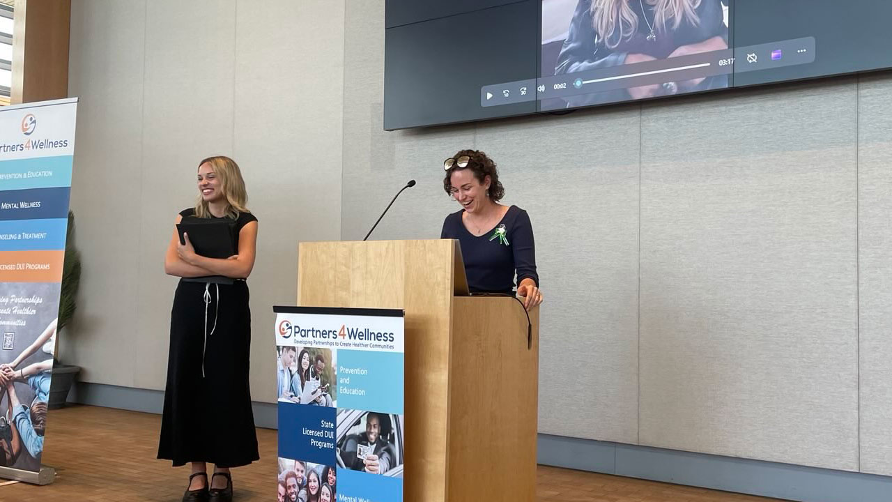 Christina and Emily smiling together at a community event